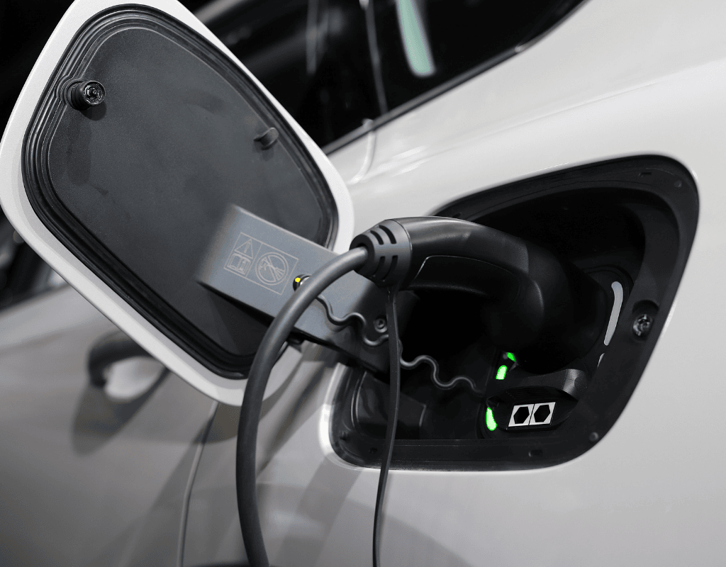 Electric vehicle charging cable plugged into car during EV charger installation service in North Shore MA